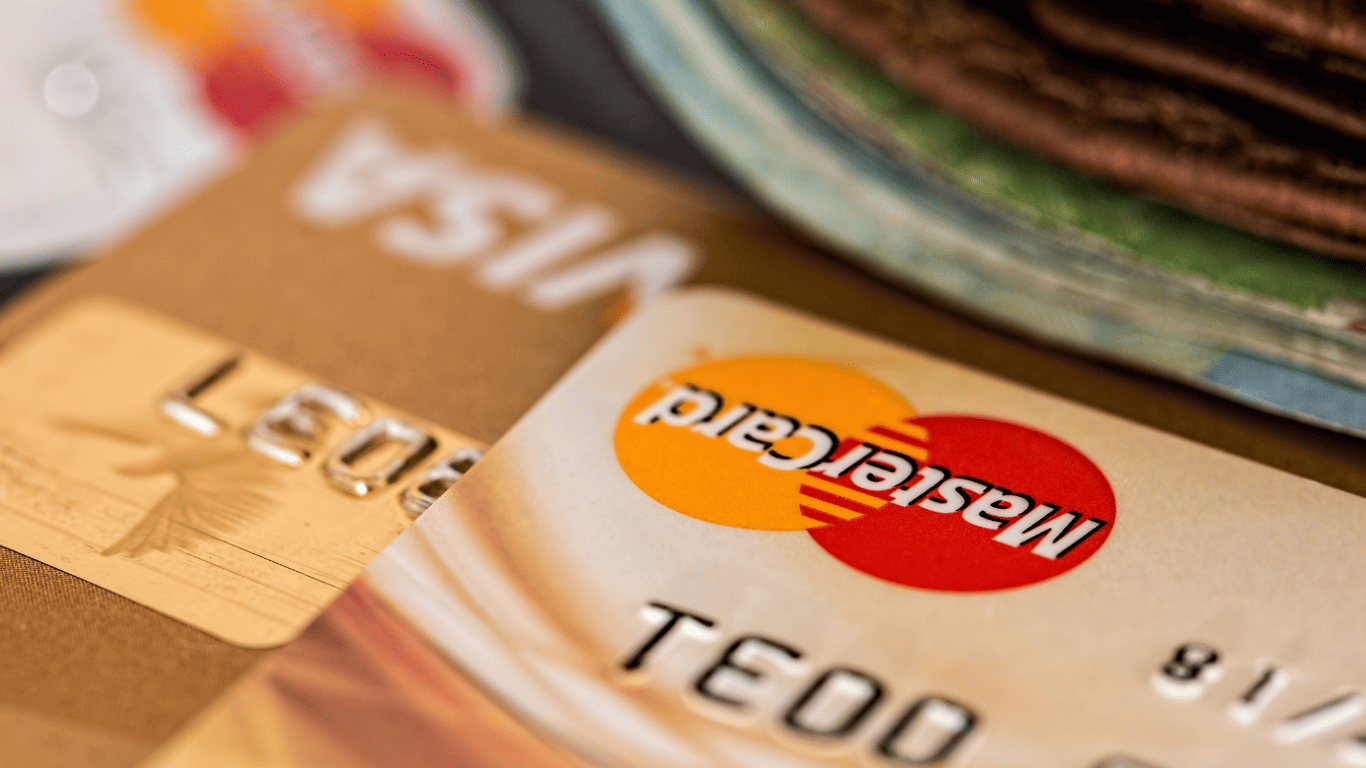 Close-up of Visa and Mastercard credit cards stacked together.